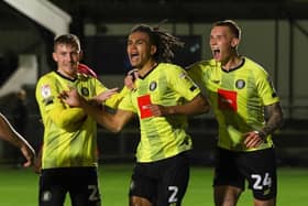 Miles Welch-Hayes, centre, is congratulated by Matty Daly, left, and Kyle Ferguson after scoring Harrogate Town's 96th-minute winner against Morecambe on Tuesday evening. Picture: Matt Kirkham