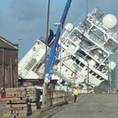 A ship is currently leaning towards the docks at a worrying angle in Leith, Edinburgh. (Photo credit: @Tomafc83 on Twitter)