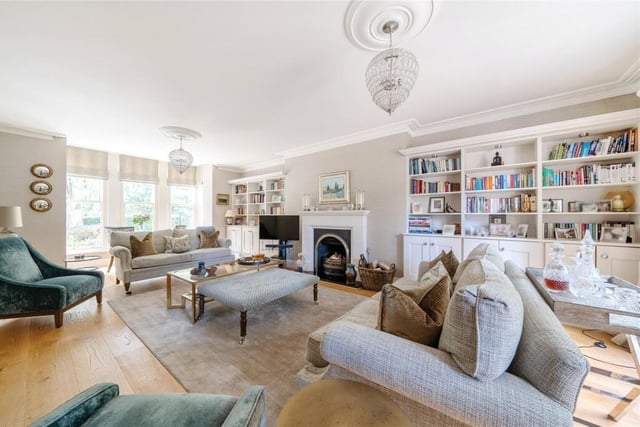 A bright and spacious main reception room with feature fireplace.