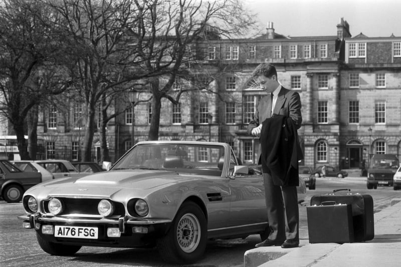 Posed picture of a young businessman beside an Aston Martin Volante car in Charlotte Square Edinbugh, April 1987.