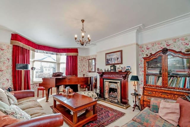 A feature fireplace is a focal point of this reception room with bay window.