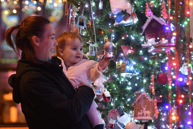 Kim Watson and her 17-month-old daughter Isla Watson admiring one of the beautiful trees on display