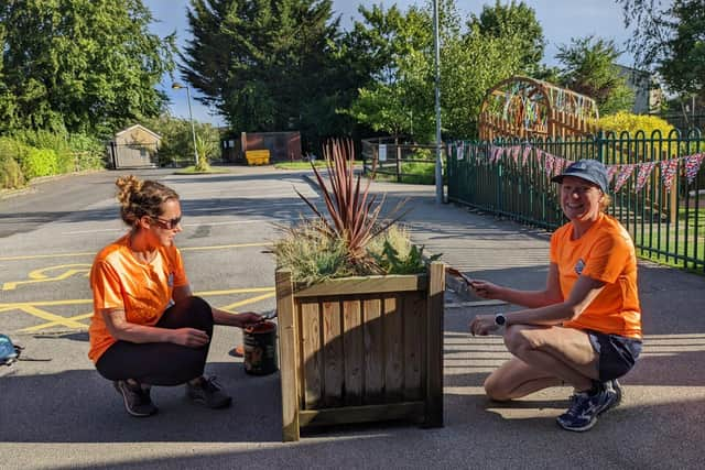 Community Fit volunteers painting a planter at Saltergate Primary School