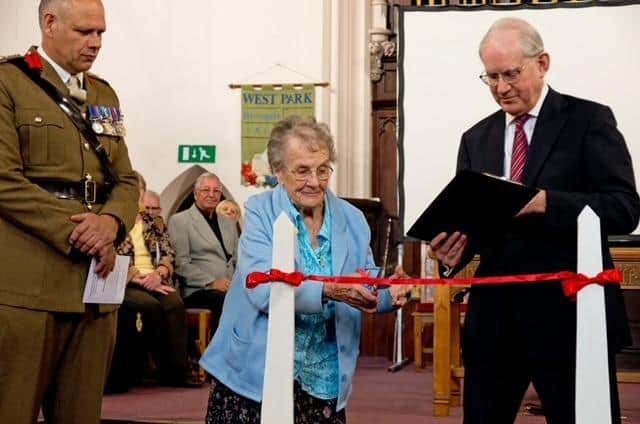The cutting of a ribbon at West Park United Reform Church by Harrogate war veteran Sheila Pantin, 99, one of the first British servicewomen to enter a concentration camp in April 1945. (Picture Mike Hudson/Harrogate Photographic Society)