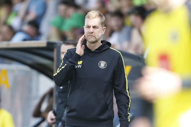 Harrogate Town manager Simon Weaver watches on from his technical area.
