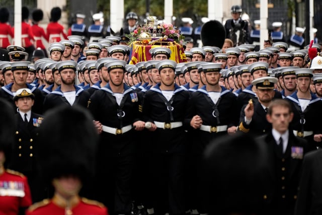 The coffin of Queen Elizabeth II with the Imperial State Crown resting on top surrounded by members of the Royal Navy is carried into Westminster Abbey.  (Photo by Christopher Furlong/Getty Images)