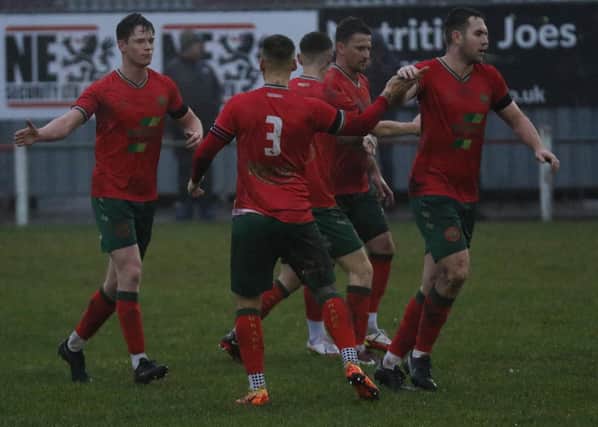 Harrogate Railway captain Dan McDaid (3) is congratulated by his team-mates after nodding in the only goal of the game during New Year's Eve's win over Brigg Town. Picture: Craig Dinsdale