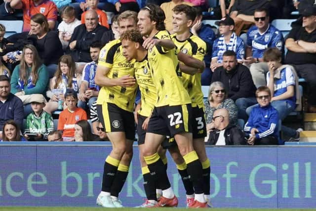 Stephen Duke-McKenna is congratulated by his Harrogate Town team-mates after opening the scoring in the 16th minute of Saturday's League Two win at Gillingham. Picture: Harrogate Town AFC