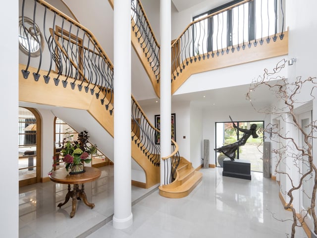A stunning hallway with feature staircase.