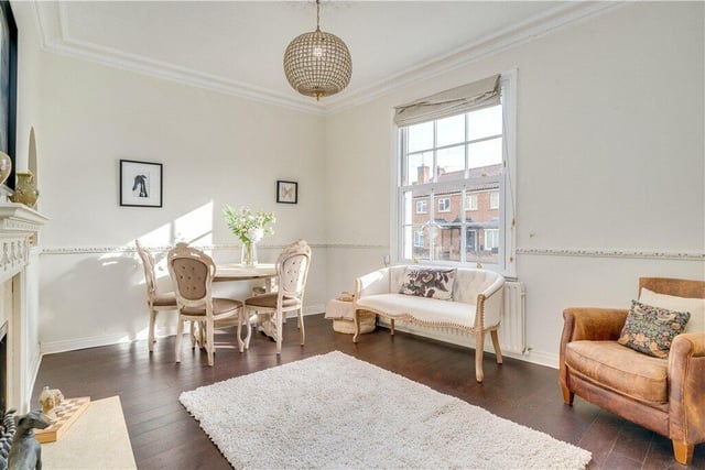 Another lovely ground floor room with engineered oak flooring, a period fireplace surround and a gas fire within.