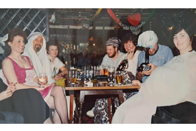 An adults costume event which is also being filmed by Dave Hubbert at what appears to be Christmas time.