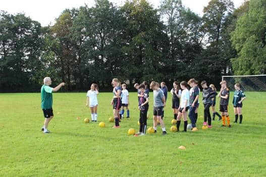 Tadcaster Grammar Year nine students taking part in a training session with Nigel Thewlis, lead coach of The Leeds United Foundation