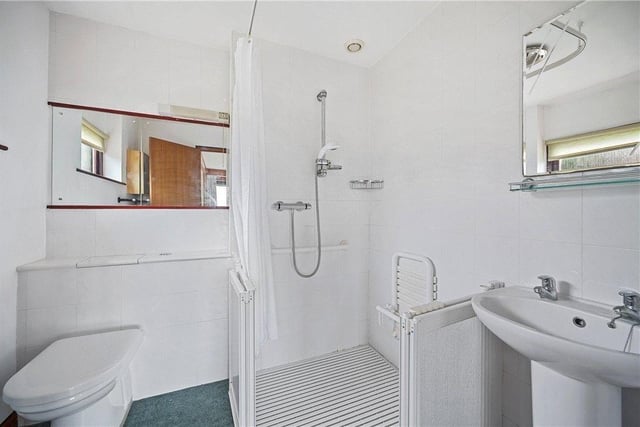 A shower room with walk-in shower unit.