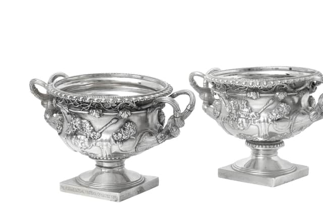 A Pair of George V Silver Copies of the Warwick Vase sold for £3,000.