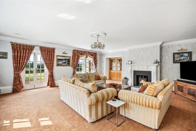 A dual aspect sitting room with feature fireplace.