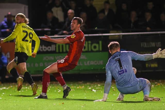 Luke Armstrong beats Carlisle United goalkeeper Tomas Holy to register Harrogate Town's first goal of the evening. Pictures: Matt Kirkham