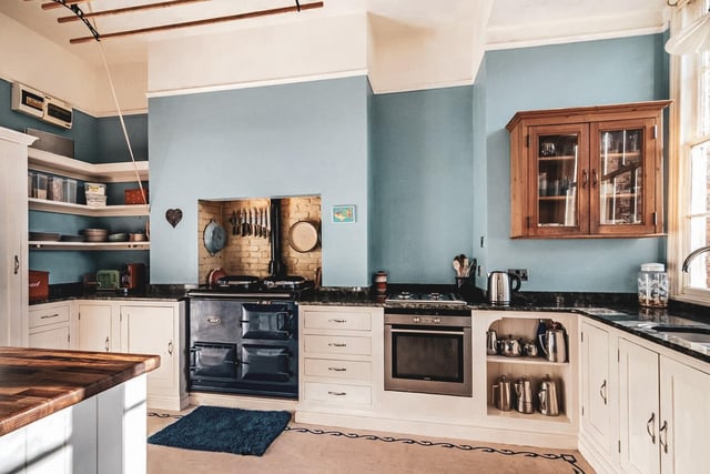 The traditional kitchen and breakfast room has complimentary views of the rear garden and features an array of bespoke and in-keeping wooden cabinetry.