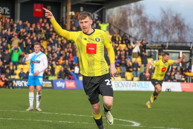 Matty Daly celebrates after netting Harrogate Town's 74th-minute winner against Barrow.