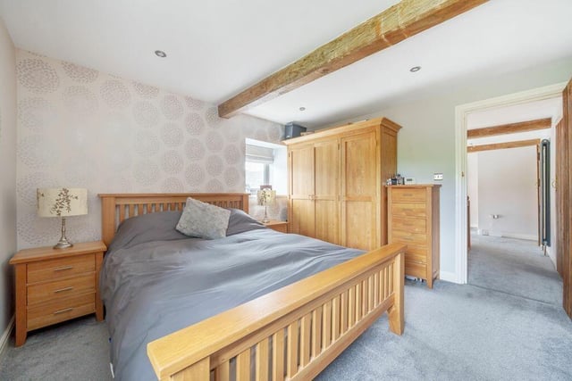 A beamed double bedroom. Four bedrooms include one main one with an en suite.