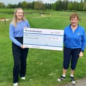 Ripon City Golf Club’s lady captain, Christine Pickard, right, hands over a cheque for £2,000 to Dementia Forward. Picture: Submitted