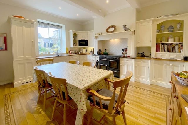 The spacious breakfast kitchen with fitted units and display cabinets.
