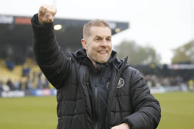 Harrogate Town manager Simon Weaver celebrates with the home fans after his team beat Fleetwood 3-1 at Wetherby Road to secure their Football League status. Pictures: Paul Thompson/ProSportsImages