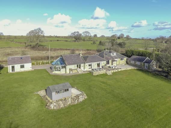 The distinctive property stands surrounded by lovely countryside, with south facing gardens and summer house.
