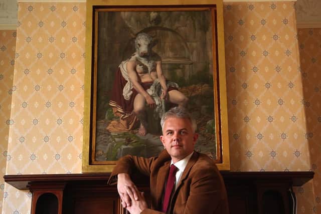 The late Harrogate 108 Fine Art co-owner Andrew Stewart pictured in 2005 in the gallery with a painting by Paul Reid. (Picture by Gered Binks)