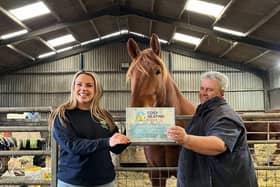 Mr Dunnett receiving his certificate on his farm.