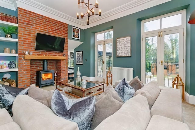 The snug or family room has a rustic brick fireplace with a solid fuel burning stove, and French doors to Juliet balconies.