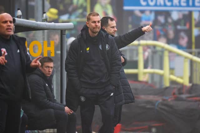 Harrogate Town manager Simon Weaver watches on from inside his technical area.