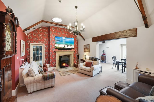 A spacious reception room with feature stone fireplace and circular skylights.
