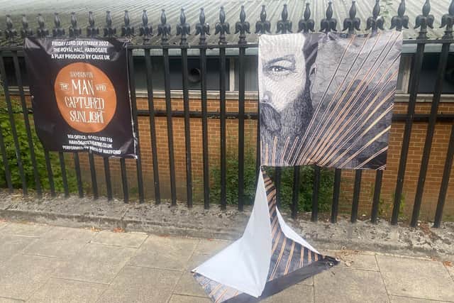 The vandalised banner in Harrogate promoting the new stage play The Man Who Captured Sunlight.