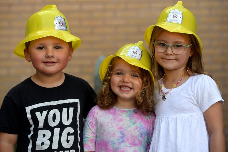 Jakey Boswell (aged four), Sadie Boswell (aged four) and Darcie Clougher (aged four) enjoying a day out in their fireman hats