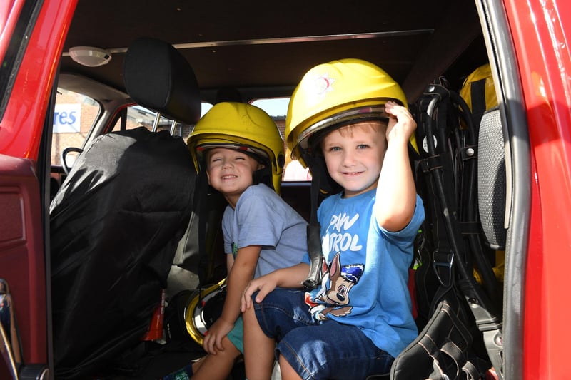 William Bloor (aged five) and his brother Henry Bloor (aged three) sitting in the driver's seat of a fire engine