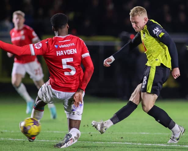 Dean Cornelius slots home Harrogate Town's first goal during Tuesday night's 2-2 draw at home to Wrexham. Pictures: Matt Kirkham