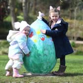 Two-year-old Libby Hewick and four-year-old Maddie Simpson with one of the giant eggs