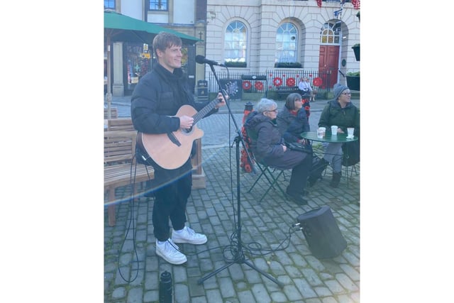 Pictured: Musician Freddie Cleary entertains visitors during the Little Birds Sunday market.