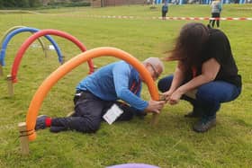 A "Help out Harrogate" volunteer sets up an obstacle course