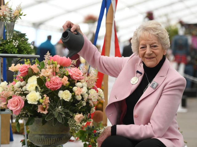 Pat Daley, Chairman of the Yorkshire Flower Club, watering the 'In Celebration of King Charles III' floral display