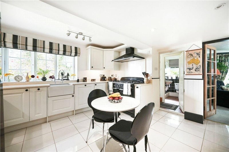 The kitchen with diner is filled with natural light.