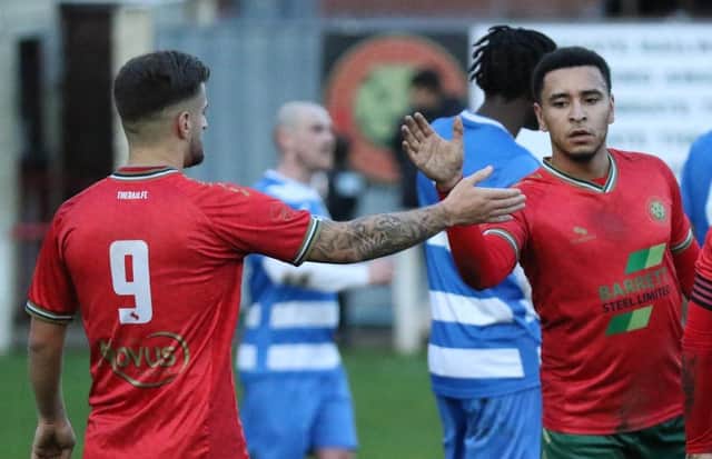 Luke Stewart, right, is congratulated by team-mate Albert Ibrahimi during Harrogate Railway's 6-1 rout of Glasshoughton Welfare. Stewart finished the game with a hat-trick to his name. Picture: Craig Dinsdale