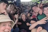 Ruth Savage with the 16 pupils who rescued her after she broke her leg in Laos