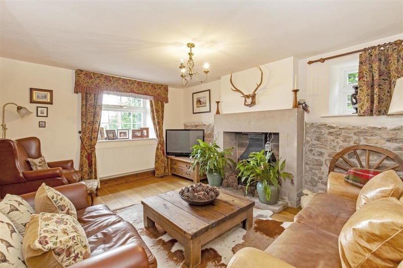 Cosy sitting room/snug. Stone inset hearth and open grate/feature stone wall. Views.