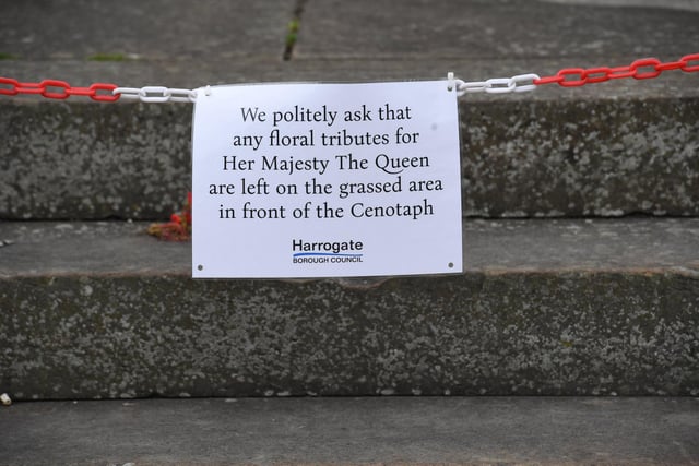 Council notice on the steps of the Cenotaph in Harrogate asking residents to leave their floral tributes on the grass.