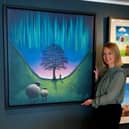 Artist Lucy Pittaway with a canvas of her painting of the Sycamore Gap tree