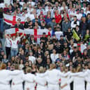 The England team lining up in front of the crowd.