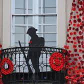 Ripon Town Hall decorated with hand knitted poppies and a wooden soldier to mark Remembrance Day