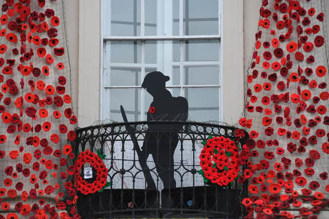 Ripon Town Hall decorated with hand knitted poppies and a wooden soldier to mark Remembrance Day