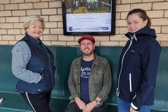Harrogate musician, artist and Northern rail staff member, Paul Mirfin with the owners of the Old Ticket Office Cafe at of Knaresborough Station where the fundraising auction will take place. (Picture contributed)